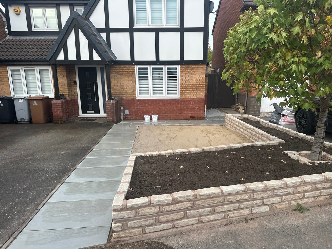 Bin storage area built into the sandstone path layout on the White Park Close front garden project